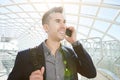 Smiling business man on mobile phone call with bag Royalty Free Stock Photo