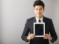 Smiling business man showing tablet pc Royalty Free Stock Photo