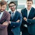 Smiling business man standing in front of the business team Royalty Free Stock Photo