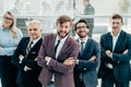 Smiling business man standing in front of the business team Royalty Free Stock Photo