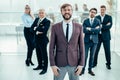 smiling business man standing in front of the business team Royalty Free Stock Photo