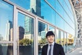 Smiling business man standing in front of  office building Royalty Free Stock Photo