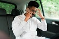 Smiling indian business man talking on cell phone and sitting in rear of the car Royalty Free Stock Photo