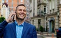 Smiling Business Man Talking On Mobile Phone In The City Royalty Free Stock Photo