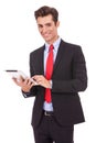 Smiling business man using his tablet pad Royalty Free Stock Photo