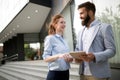 Smiling business man and woman chatting outdoor