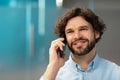 Smiling business man working and talking on phone at office Royalty Free Stock Photo