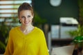 Smiling business owner woman standing in green office Royalty Free Stock Photo