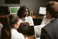 Smiling business people have conversation working at same desk in open space office. Brainstorming concept. Teamwork Royalty Free Stock Photo