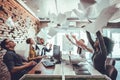 Smiling business people having fun by throwing papers in the air celebrating business success in the modern office Royalty Free Stock Photo