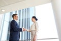 Smiling business people shaking hands at office Royalty Free Stock Photo