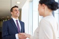 Smiling business people shaking hands at office Royalty Free Stock Photo