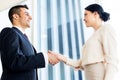 Smiling business people shaking hands at office Royalty Free Stock Photo