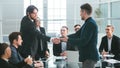 Smiling business people shaking hands over an office Desk Royalty Free Stock Photo