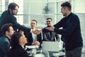 Smiling business people shaking hands over an office Desk Royalty Free Stock Photo