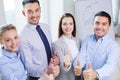 Smiling business people showing thumbs up Royalty Free Stock Photo