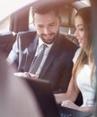 Smiling business people working in backseat of car Royalty Free Stock Photo