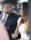 Smiling business people working in backseat of car Royalty Free Stock Photo