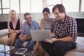 Smiling business people working on laptop at office Royalty Free Stock Photo