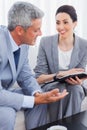 Smiling business people working and talking together on sofa Royalty Free Stock Photo