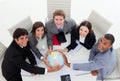 Smiling Business team holding a terrestrial globe Royalty Free Stock Photo