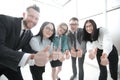 Smiling business team looking at the camera and showing thumbs up Royalty Free Stock Photo