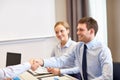 Smiling business team shaking hands in office Royalty Free Stock Photo