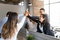 Business people giving each other high fives in office Royalty Free Stock Photo