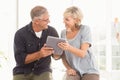 Smiling business team working over a tablet Royalty Free Stock Photo