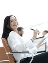 Smiling business woman with financial documents sitting at work desk. Royalty Free Stock Photo