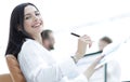 Smiling business woman with financial documents sitting at work desk. Royalty Free Stock Photo