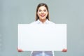 Smiling business woman hold big white blank sign board. Royalty Free Stock Photo