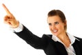 Smiling business woman pointing finger in corner Royalty Free Stock Photo