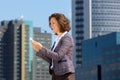 Smiling business woman reading text message on cell phone Royalty Free Stock Photo