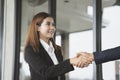 Smiling business woman shaking hands in the office building Royalty Free Stock Photo