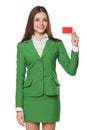 Smiling business woman showing blank credit card in green suit, isolated over white background