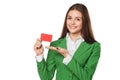 Smiling business woman showing blank credit card in green suit, isolated over white background