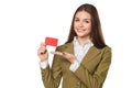 Smiling business woman showing blank credit card in green suit, over white background