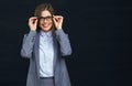 Smiling business woman touching her glasses. Royalty Free Stock Photo