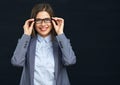 Smiling business woman touching her glasses. Royalty Free Stock Photo