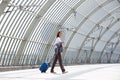 Smiling business woman walking with bag at station Royalty Free Stock Photo