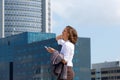 Smiling business woman walking in the city with cell phone Royalty Free Stock Photo