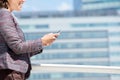 Smiling business woman walking and using mobile phone Royalty Free Stock Photo