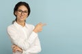 Smiling business woman wear white blouse and glasses pointing with finger, showing at copy space Royalty Free Stock Photo