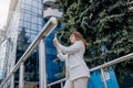 Smiling business woman in white suit and sunglasses making selfie using phone during break standing near modern office building Royalty Free Stock Photo