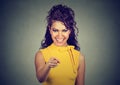 Smiling business woman in yellow dress pointing finger at viewer Royalty Free Stock Photo