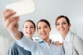 Smiling business women team taking a selfie Royalty Free Stock Photo