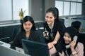 Smiling business women team working at office desk and discussing a project on computer Royalty Free Stock Photo