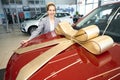 Happy lady holding hands on red carhood Royalty Free Stock Photo