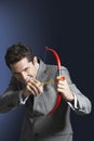 Smiling Businessman Aiming Toy Bow And Arrow